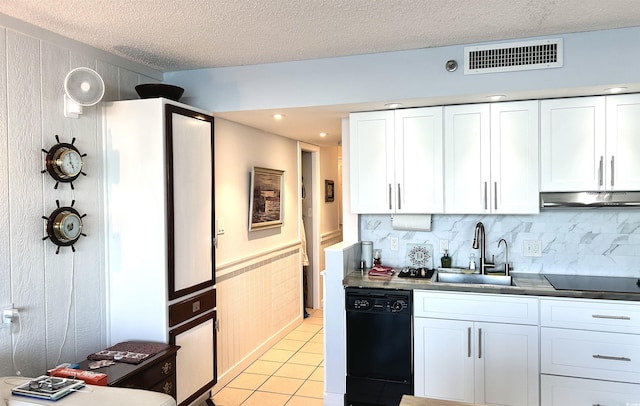 kitchen with visible vents, under cabinet range hood, light tile patterned flooring, black appliances, and a sink