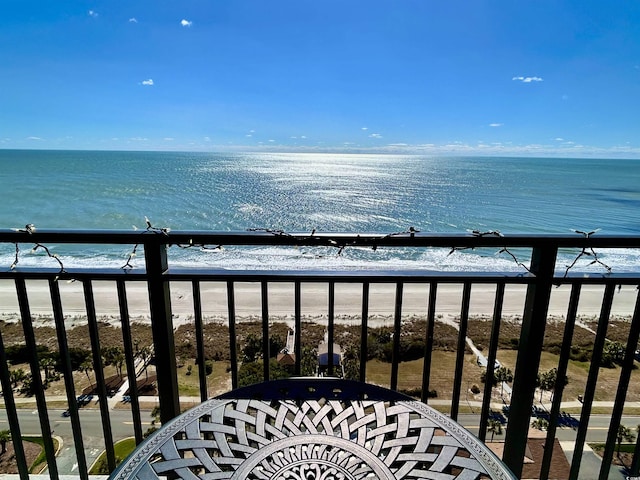 balcony featuring a water view and a beach view