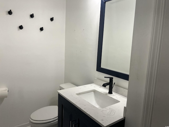 half bathroom featuring toilet and vanity