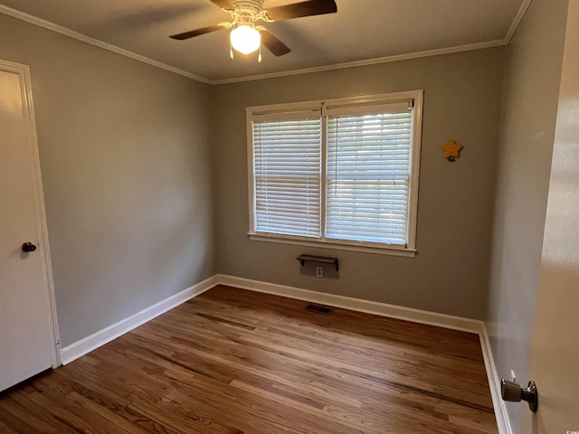 unfurnished room featuring a ceiling fan, baseboards, ornamental molding, and wood finished floors