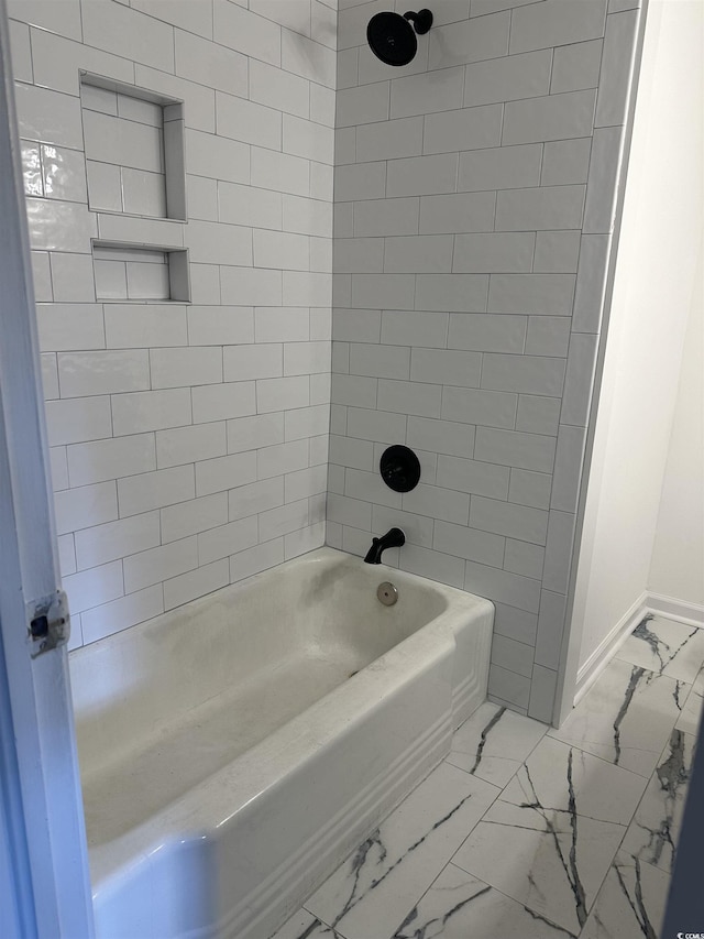 full bathroom with marble finish floor, shower / bath combination, and baseboards