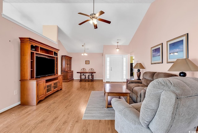 living room featuring high vaulted ceiling, light wood-style flooring, baseboards, and ceiling fan