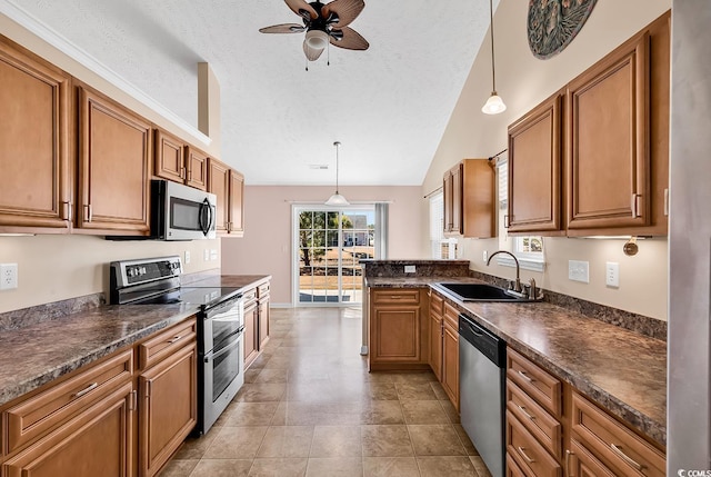 kitchen with dark countertops, appliances with stainless steel finishes, and brown cabinetry