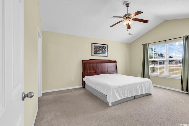 carpeted bedroom featuring lofted ceiling, visible vents, baseboards, and a ceiling fan