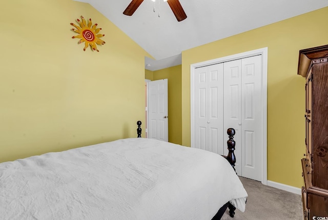 bedroom with a closet, a ceiling fan, light carpet, vaulted ceiling, and baseboards