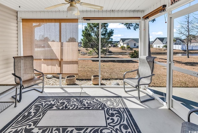 sunroom / solarium with a ceiling fan