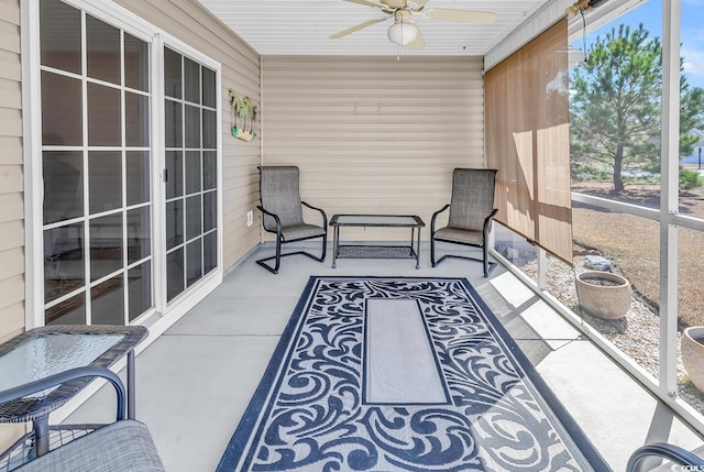 sunroom / solarium featuring ceiling fan