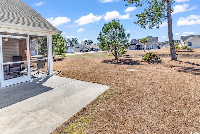 view of yard with a patio and a residential view