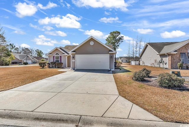 view of front facade featuring a garage, driveway, and a front lawn