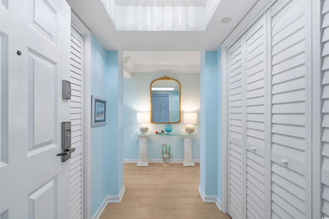 corridor featuring light wood-style floors and baseboards