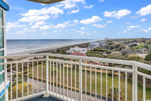 balcony with a water view and a view of the beach