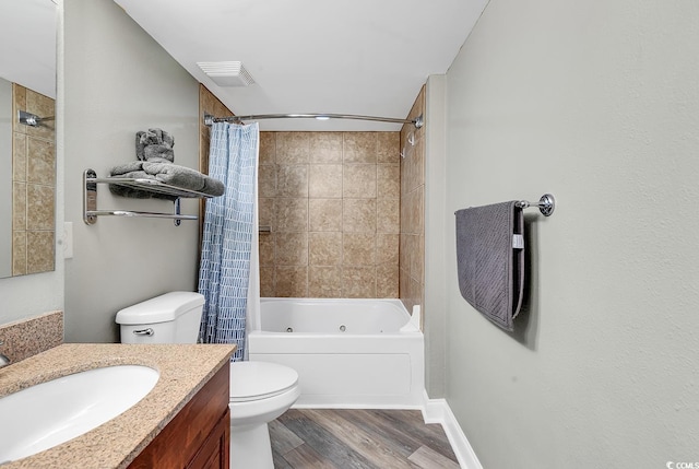 full bathroom featuring visible vents, toilet, wood finished floors, a combined bath / shower with jetted tub, and vanity