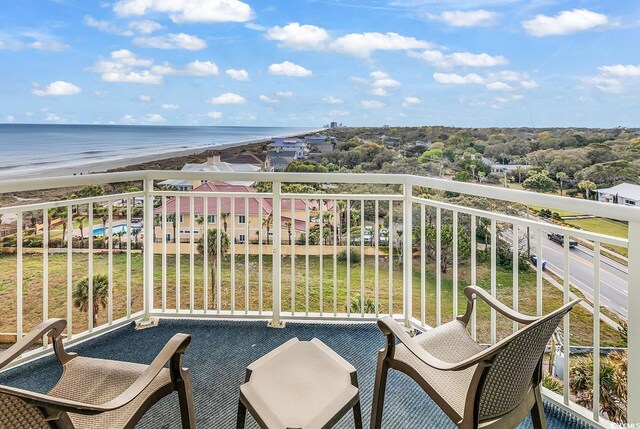 balcony with a water view and a beach view