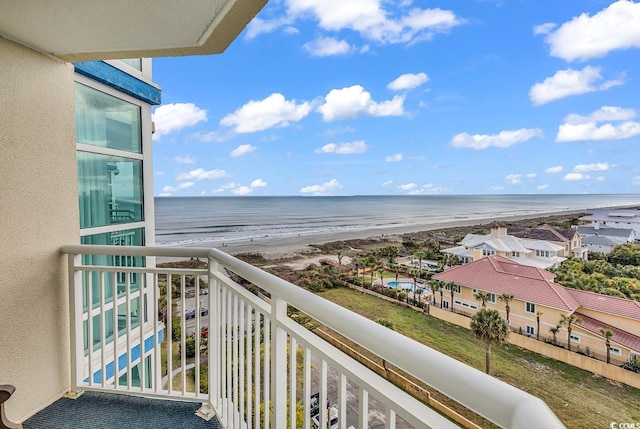 balcony with a water view and a beach view