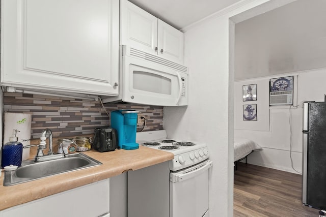 kitchen featuring white appliances, tasteful backsplash, white cabinets, and a sink