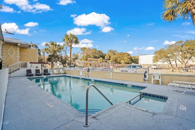 pool featuring fence and a patio