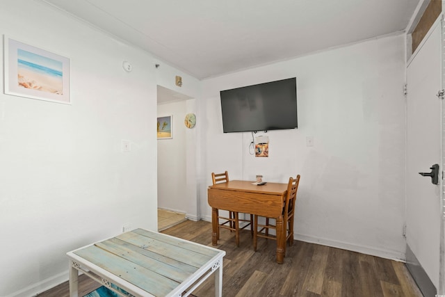 dining area featuring baseboards and wood finished floors