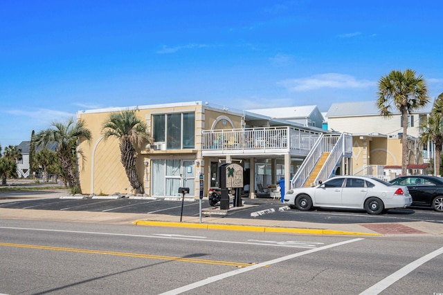 view of building exterior with uncovered parking