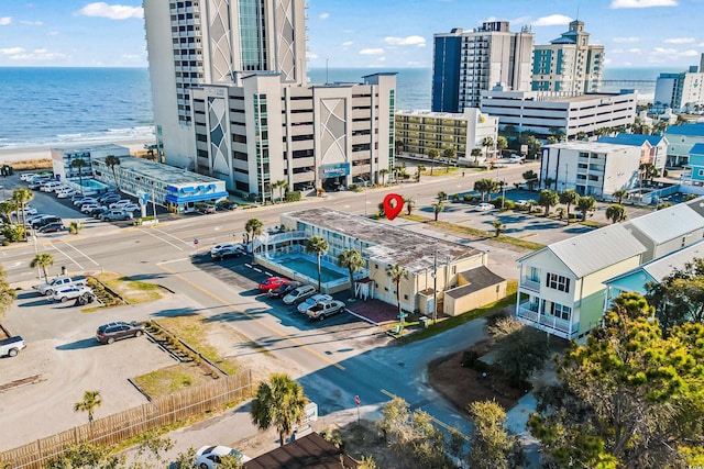 birds eye view of property with a view of city and a water view