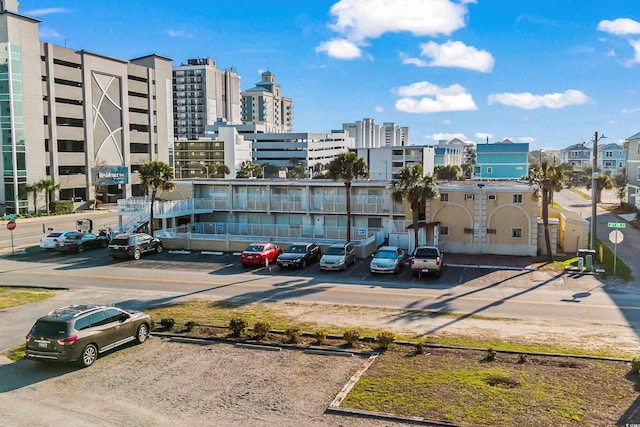 uncovered parking lot featuring a view of city