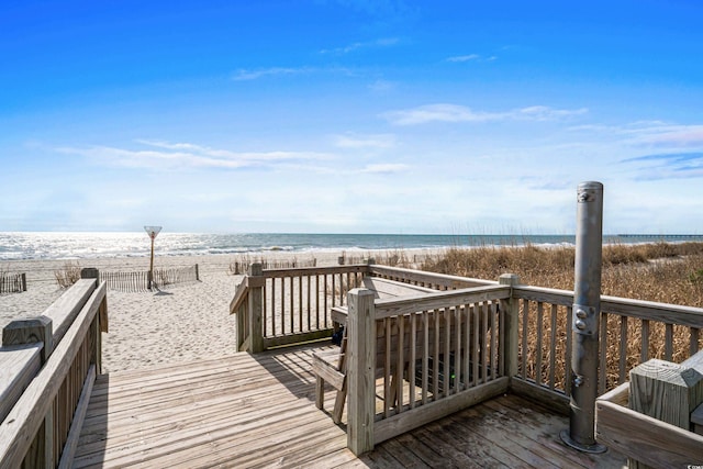 view of property's community with a beach view and a water view