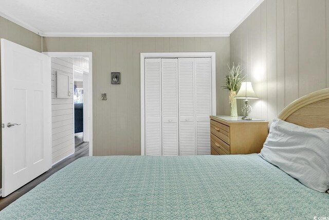 9501 Shore Dr Unit D-132, Myrtle Beach, SC 29572 - bedroom featuring ornamental molding, a closet, and wood finished floors