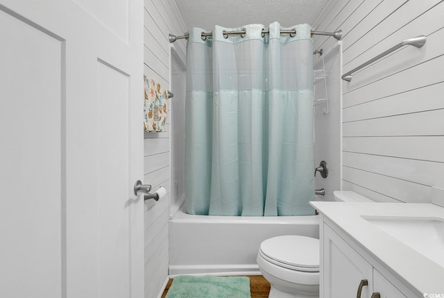 9501 Shore Dr Unit D-132, Myrtle Beach, SC 29572 - bathroom with a textured ceiling, toilet, wood walls, vanity, and shower / tub combo with curtain