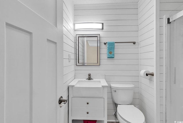 9501 Shore Dr Unit D-132, Myrtle Beach, SC 29572 - bathroom with vanity, toilet, and wooden walls