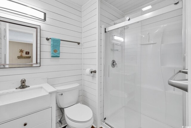 9501 Shore Dr Unit D-132, Myrtle Beach, SC 29572 - bathroom featuring toilet, a stall shower, wooden walls, and vanity