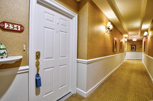 corridor featuring baseboards, carpet floors, wainscoting, and wallpapered walls