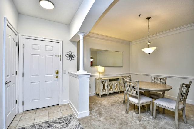 entrance foyer with baseboards, decorative columns, light tile patterned flooring, arched walkways, and ornamental molding