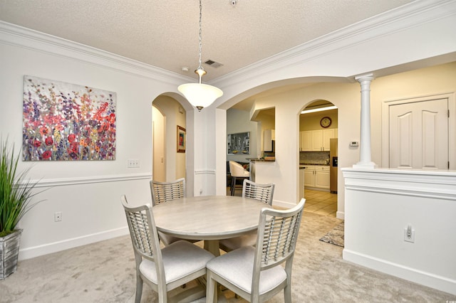 dining space featuring visible vents, light carpet, a textured ceiling, arched walkways, and crown molding