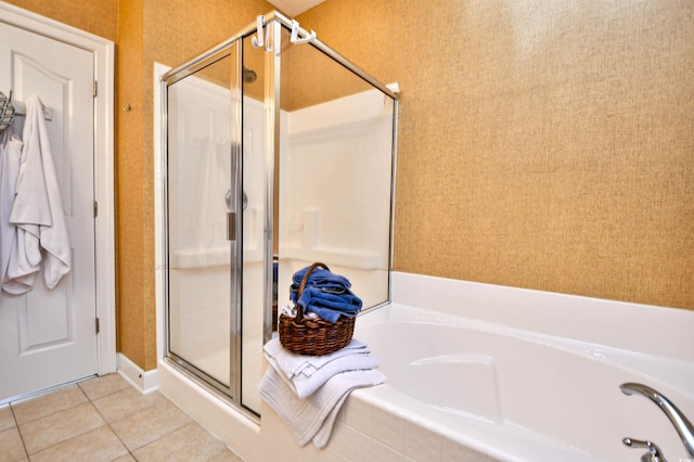 bathroom with tile patterned flooring, a stall shower, and a bath