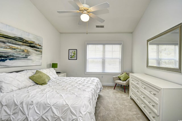 bedroom featuring visible vents, light carpet, lofted ceiling, baseboards, and ceiling fan