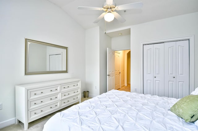 bedroom featuring a closet, baseboards, carpet, lofted ceiling, and ceiling fan