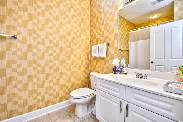 full bathroom featuring vanity, visible vents, curtained shower, tile patterned floors, and toilet