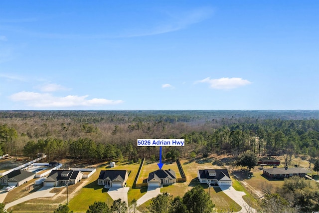 birds eye view of property with a residential view and a view of trees