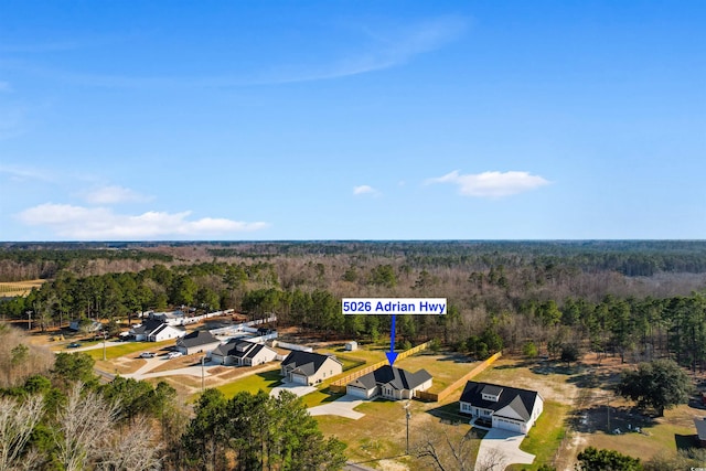 bird's eye view with a wooded view