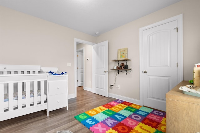 bedroom featuring wood finished floors and baseboards