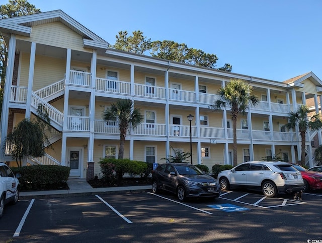 view of building exterior featuring uncovered parking