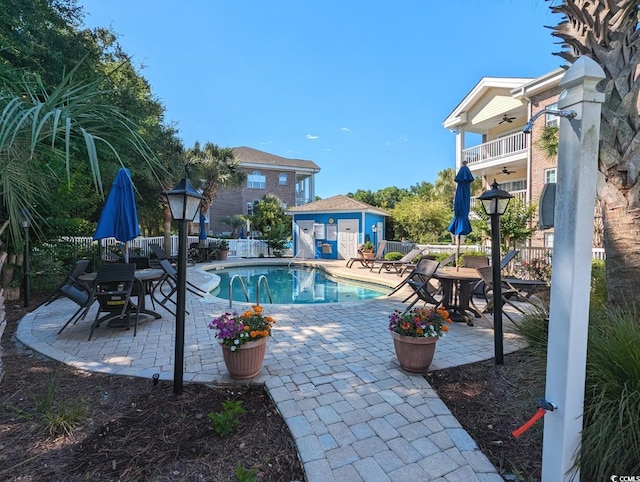 view of pool featuring ceiling fan, a patio area, fence, and a fenced in pool