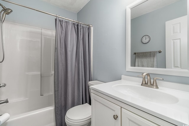 full bathroom with vanity, a textured ceiling, toilet, and shower / bath combo with shower curtain