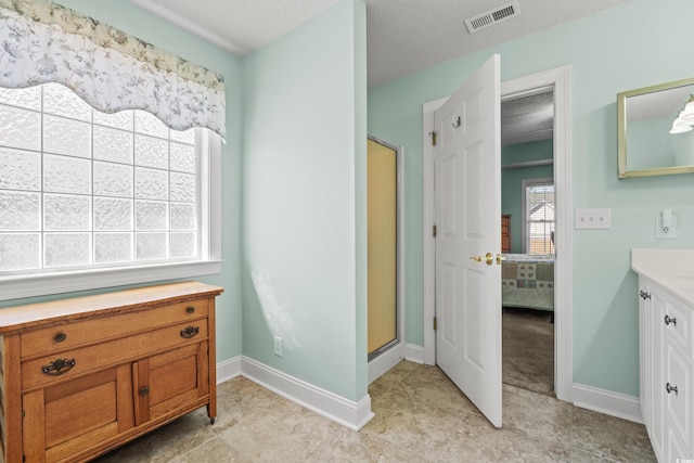 3516 Queens Harbour Blvd, Myrtle Beach, SC 29588 - ensuite bathroom featuring vanity, a shower stall, a textured ceiling, and tile patterned floors