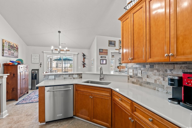 3516 Queens Harbour Blvd, Myrtle Beach, SC 29588 - kitchen with dishwasher, a peninsula, tasteful backsplash, brown cabinetry, and vaulted ceiling