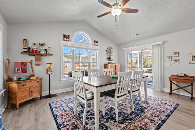 3516 Queens Harbour Blvd, Myrtle Beach, SC 29588 - dining area featuring healthy amount of natural light, a ceiling fan, light wood finished floors, vaulted ceiling, and a textured ceiling