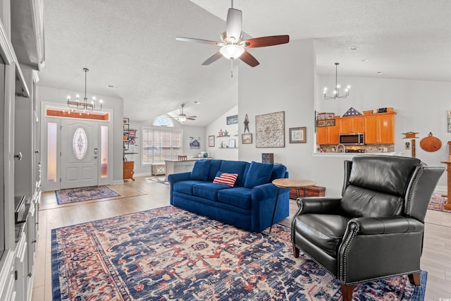 3516 Queens Harbour Blvd, Myrtle Beach, SC 29588 - living area with a chandelier, a textured ceiling, a ceiling fan, light wood-style floors, and high vaulted ceiling