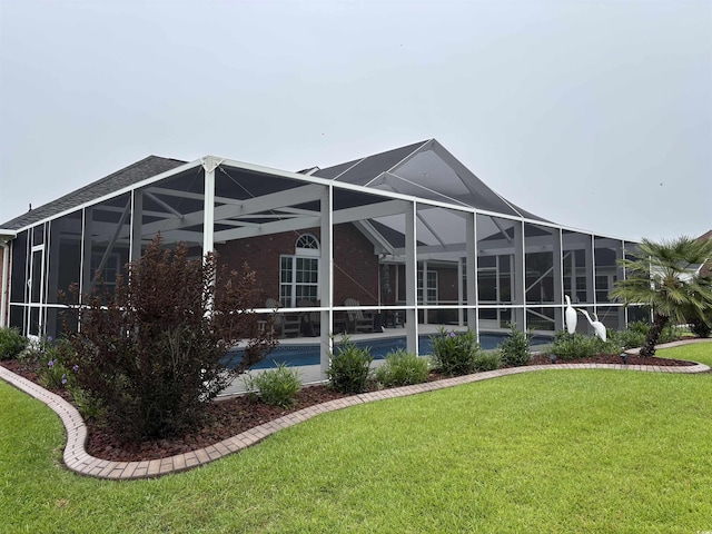 3516 Queens Harbour Blvd, Myrtle Beach, SC 29588 - back of house featuring a lawn, an outdoor pool, glass enclosure, and a patio