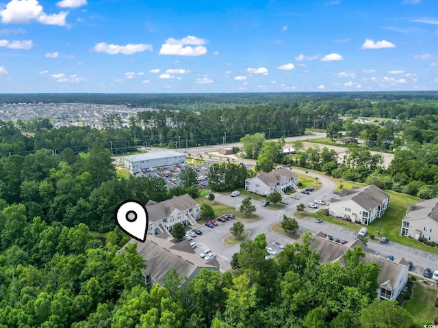 birds eye view of property with a view of trees