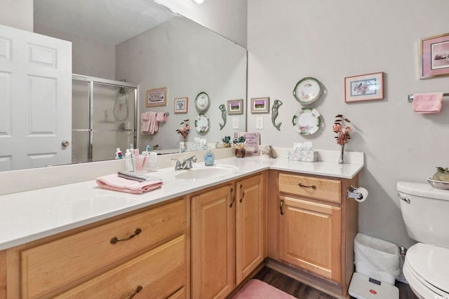 full bath with toilet, a stall shower, and vanity