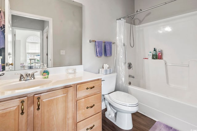 full bathroom featuring toilet, wood finished floors, shower / bath combination with curtain, and vanity